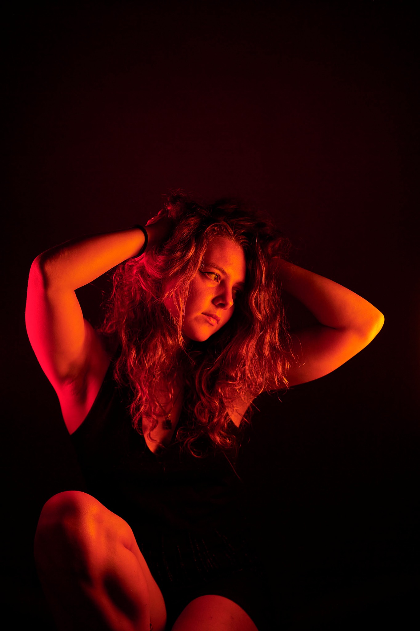 Invisible Ink artist Ellie Harris in a cinematic red portrait